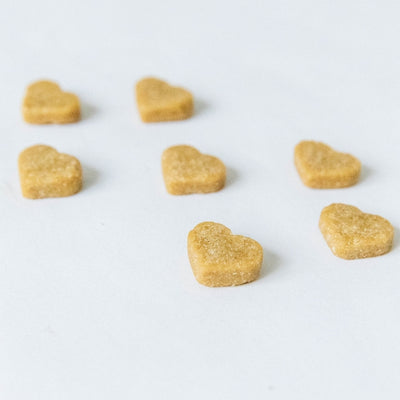 Heart-shaped dog treats on a white background